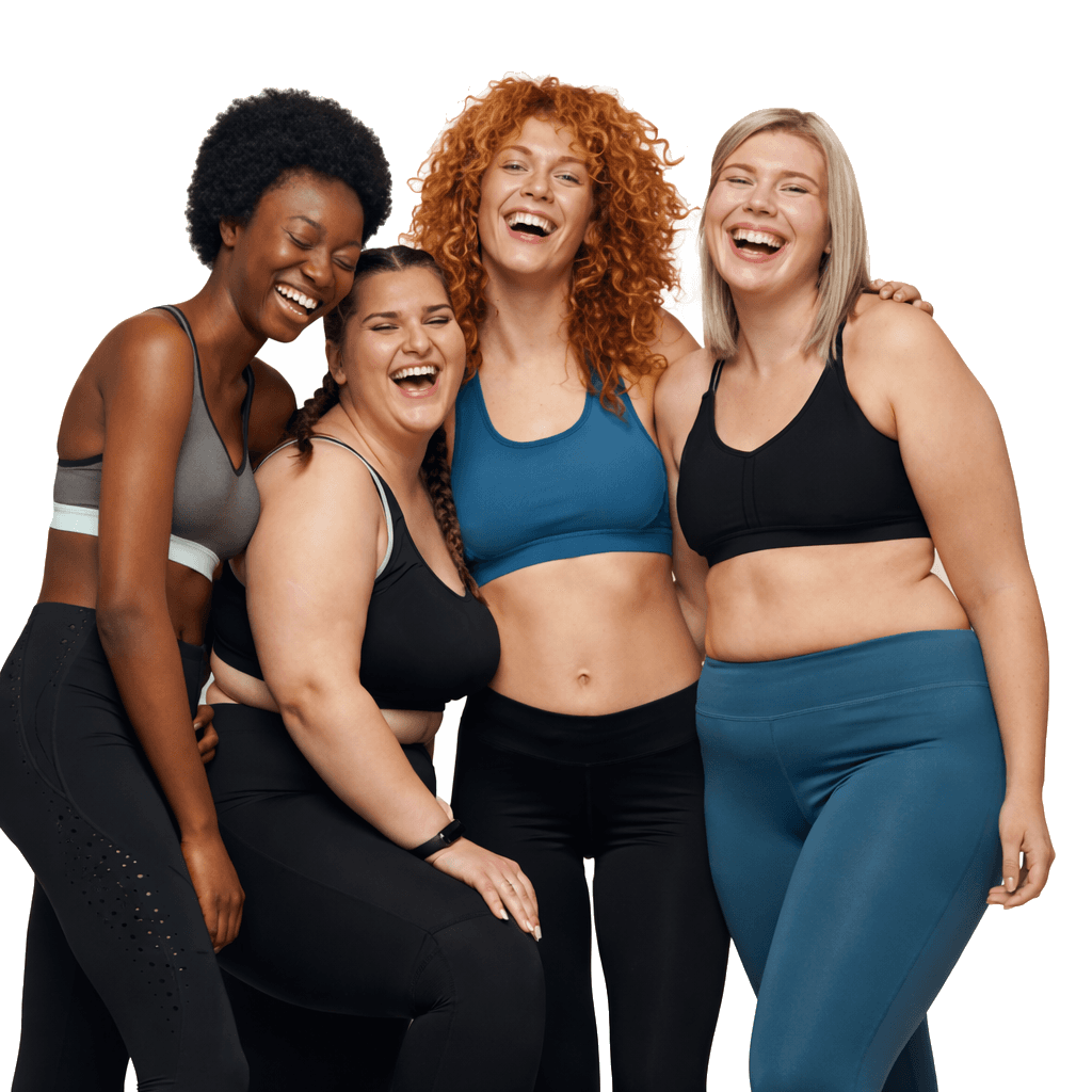 Group of women in fitness attire laughing together after a class
